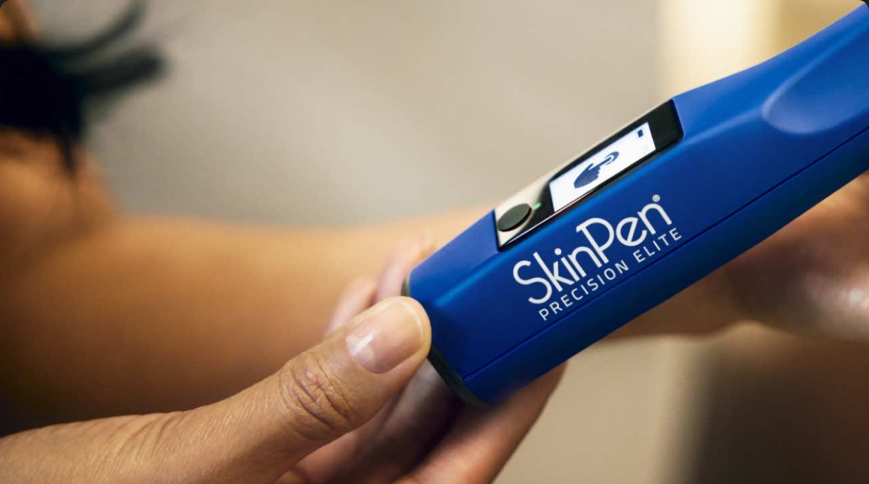SkinPen® device being held in someone's hand.